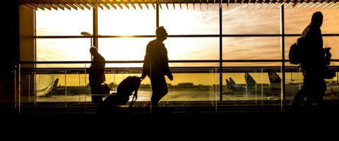 people walking through an airport