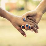 Two people holding hands