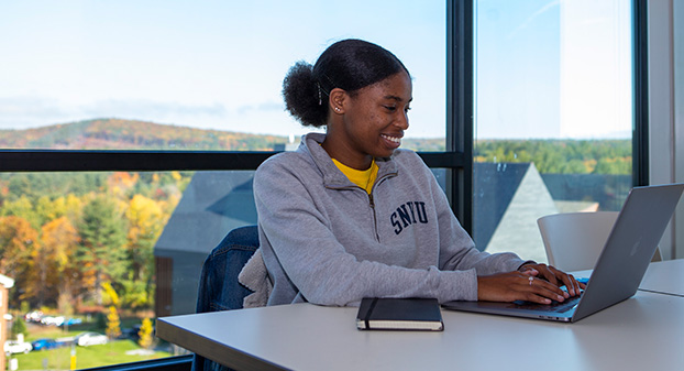 A student writing a short story for the 2020 Fall Fiction Contest.