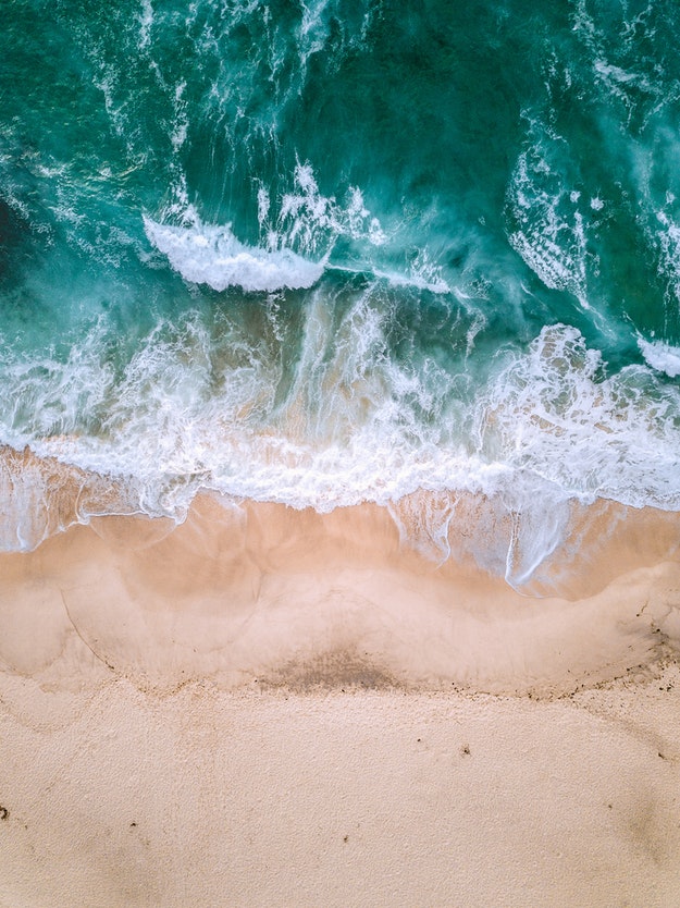 Ocean waves crashing onto a sandy beach