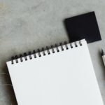 Blank piece of paper next to silver pen