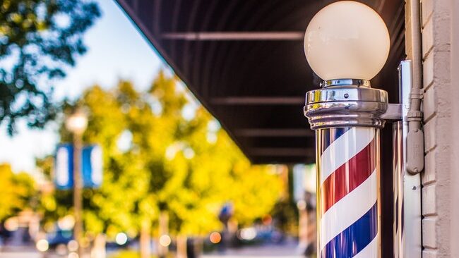 A barbershop pole with a light above it