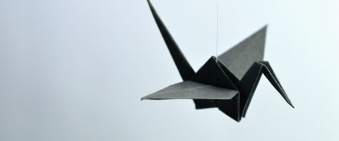 A paper origami bird hanging from a string