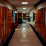 School hallway lined with red lockers