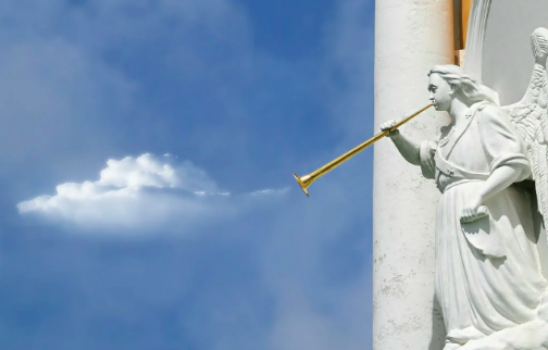 a statue of an angel appears to be blowing clouds into the sky from a horn