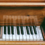 An old piano with a chipped key.