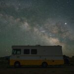 An RV under the star filled night sky